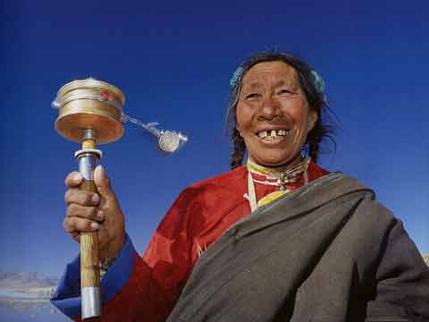 
Pilgrim Woman Spinning Prayer Wheel At Lake Manasarovar - Buddhism: Eight Steps To Happiness by Dieter Glogowski book
